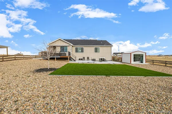 a view of a house with a yard and sitting area