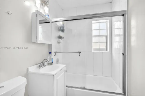 a bathroom with a sink a mirror and a shower