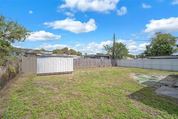 a view of a backyard with tree