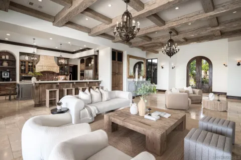 a living room with furniture and a chandelier