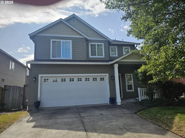 a front view of a house with garage