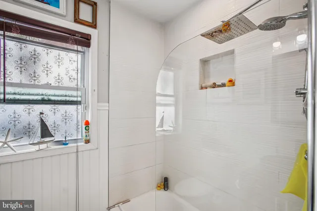 a bathroom with a bathtub and a shower