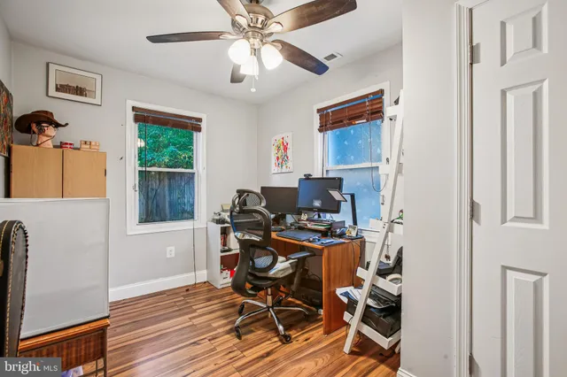 a view of a workspace with furniture and a window