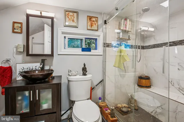 a bathroom with a toilet a sink and shower
