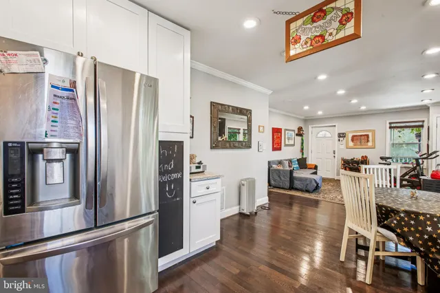a living room with furniture wooden floor and a flat screen tv