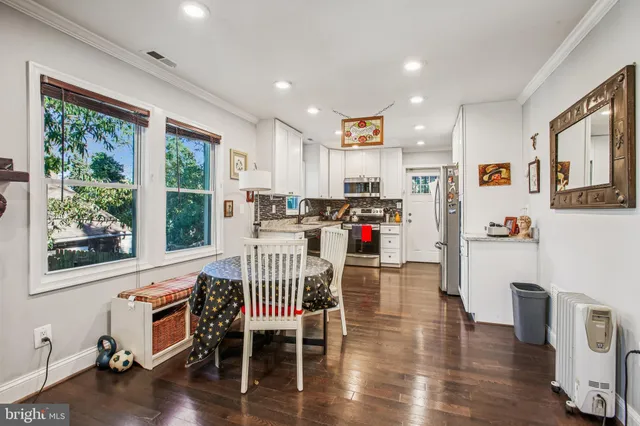 a dining room with furniture and wooden floor
