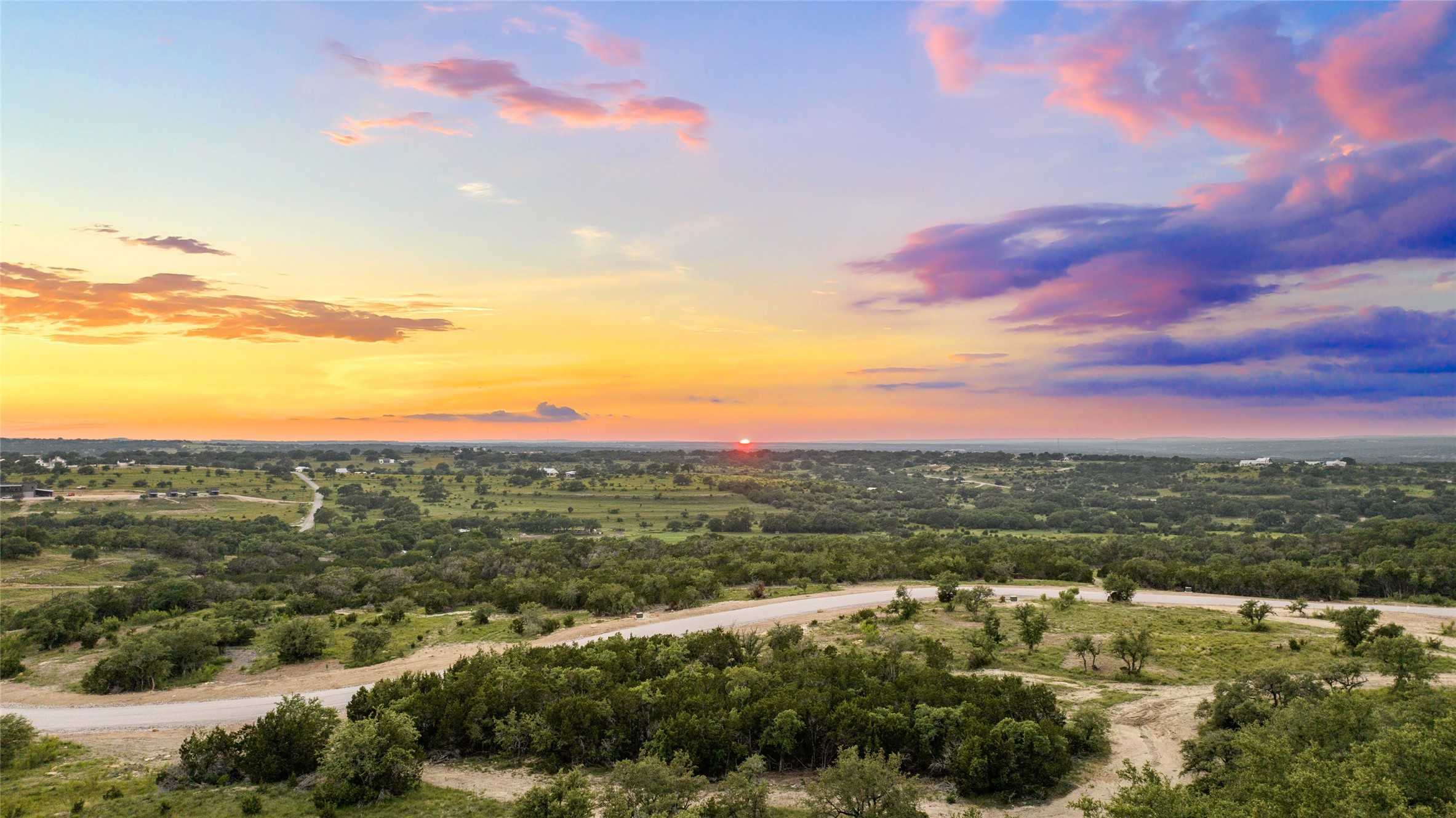 Lot 1 Sunset View Johnson City, TX 78636 - Photo 1 of 17 a view of a city with mountains