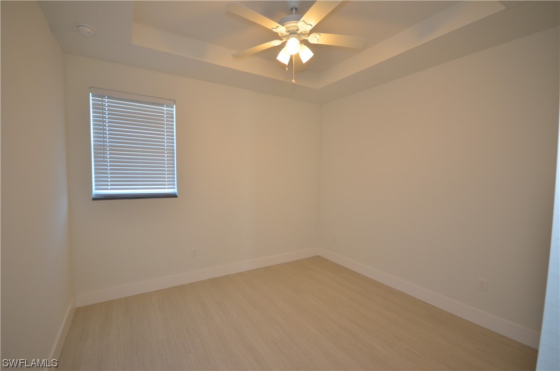 8581 Agate Street Port Charlotte, FL 33981 - Photo 11 of 50 an empty room with a window and a fan