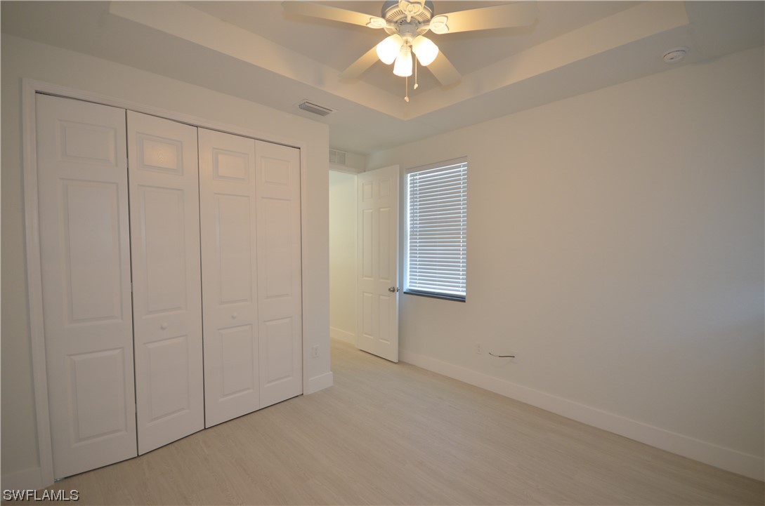 8581 Agate Street Port Charlotte, FL 33981 - Photo 12 of 50 en empty room with windows and fan