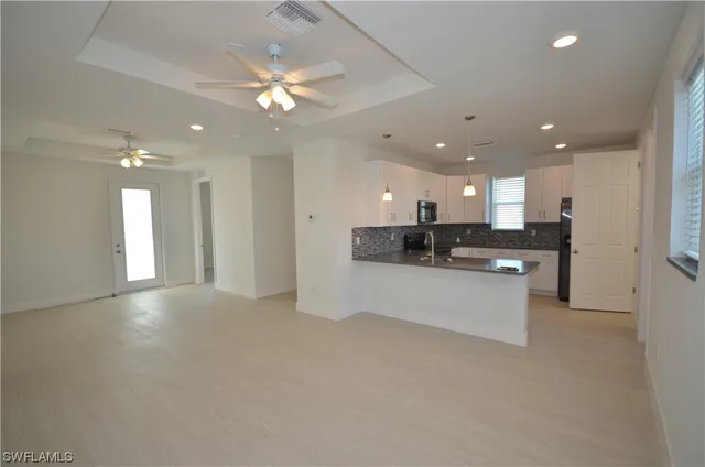 a view of kitchen with refrigerator sink and stove