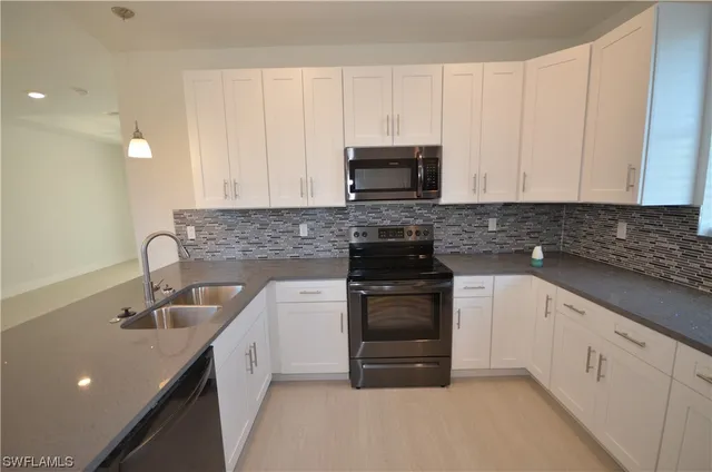 a kitchen with a sink and cabinets
