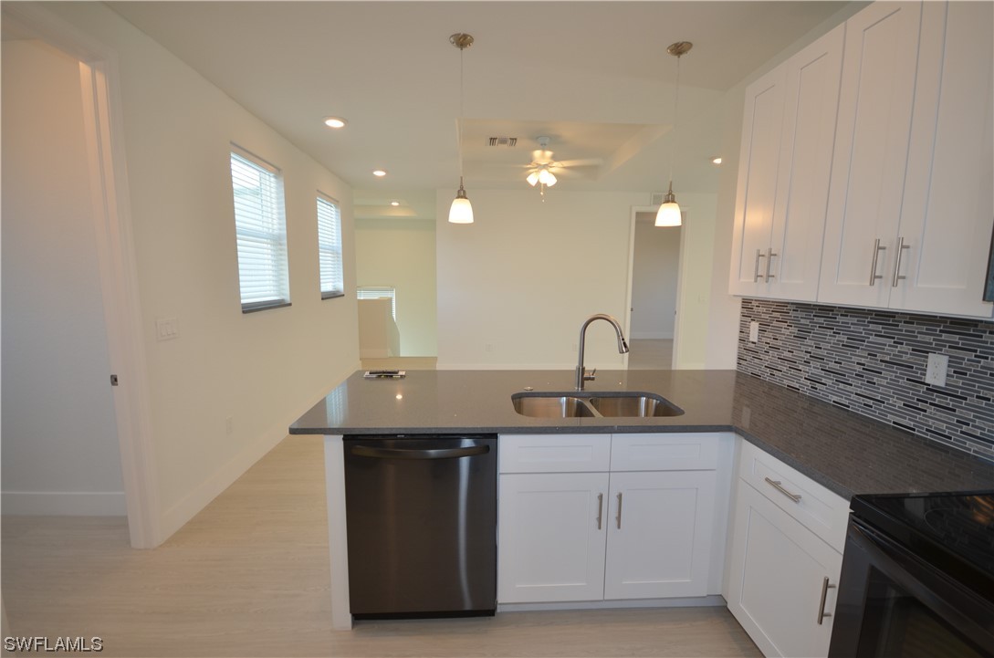 8581 Agate Street Port Charlotte, FL 33981 - Photo 19 of 50 a kitchen with a sink and cabinets
