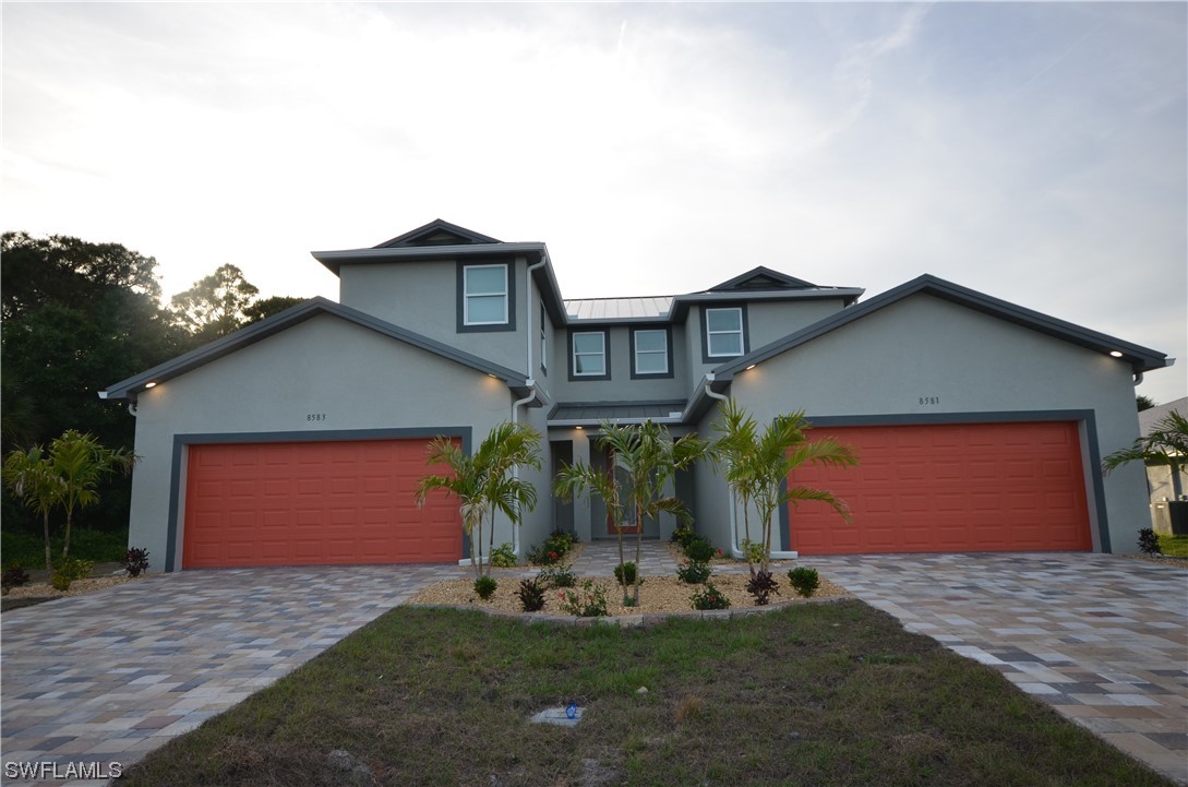 8581 Agate Street Port Charlotte, FL 33981 - Photo 2 of 50 a front view of a house with garden