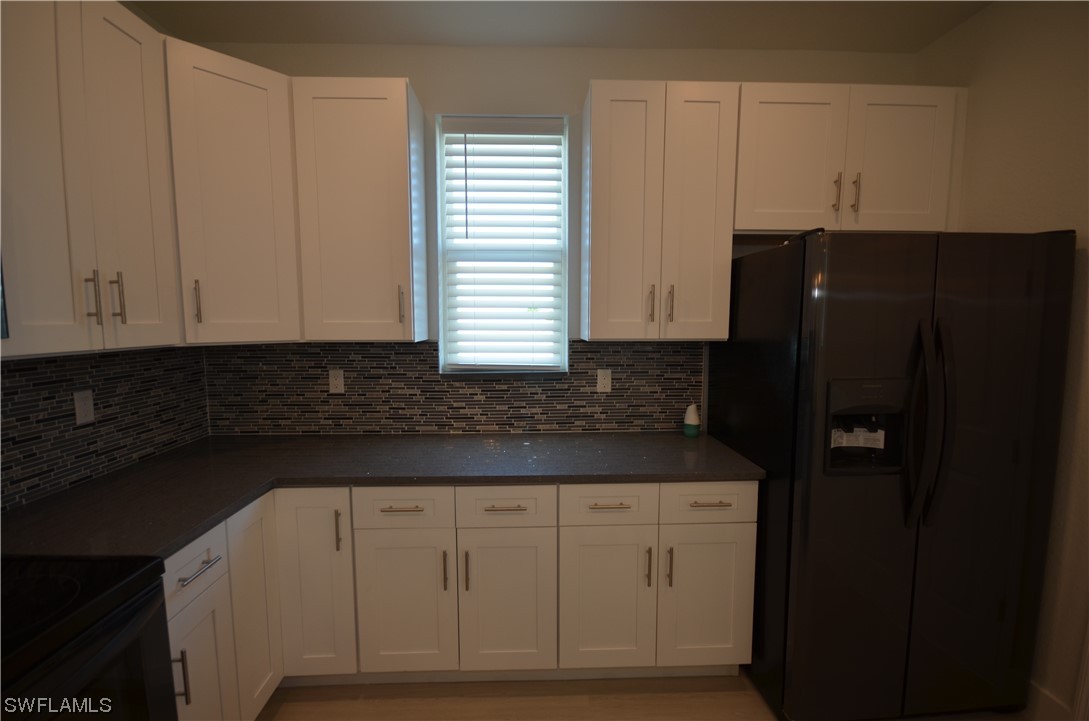 8581 Agate Street Port Charlotte, FL 33981 - Photo 21 of 50 a view of cabinets and window