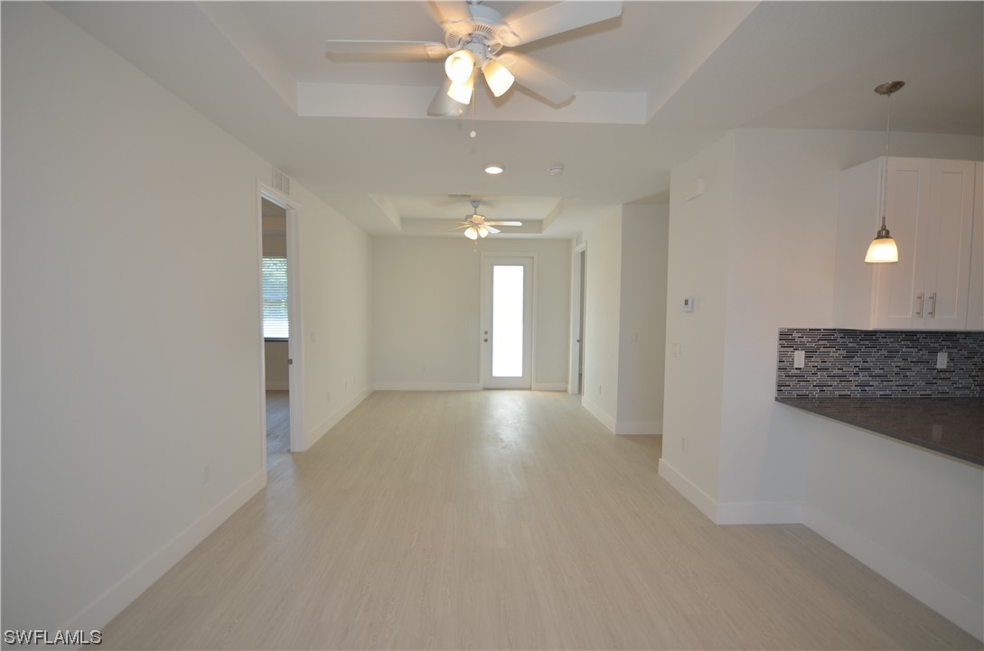 8581 Agate Street Port Charlotte, FL 33981 - Photo 23 of 50 a view of a hallway with a chandelier fan and windows
