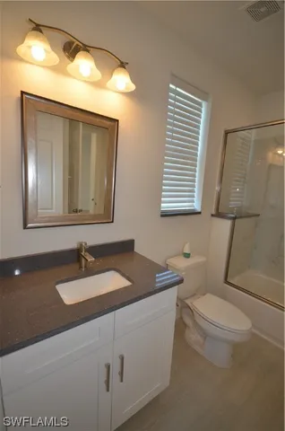 a bathroom with a toilet a sink and shower