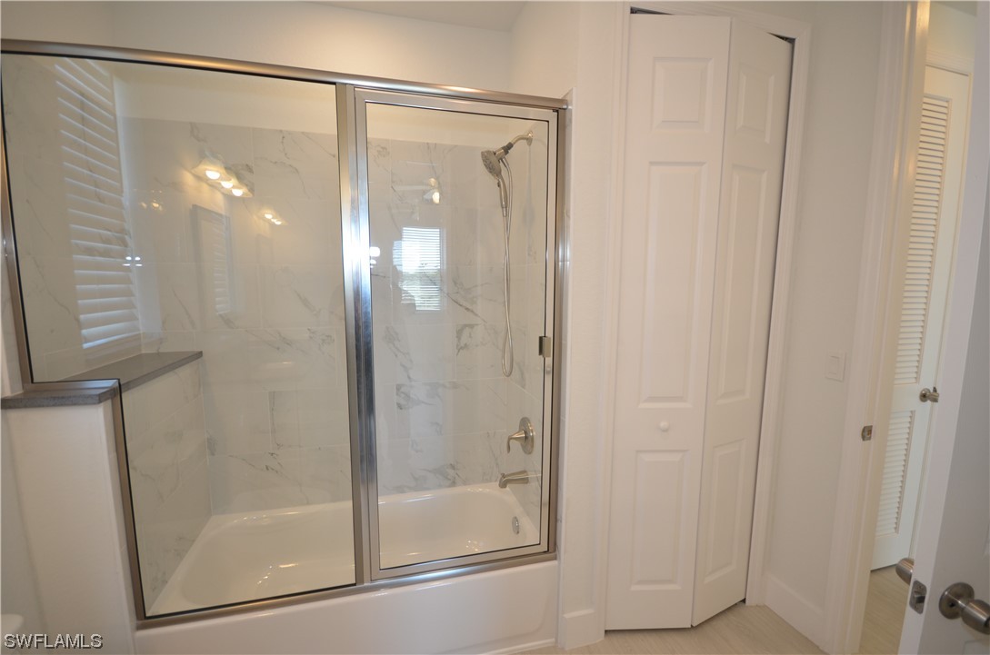 8581 Agate Street Port Charlotte, FL 33981 - Photo 27 of 50 a bathroom with a glass shower door