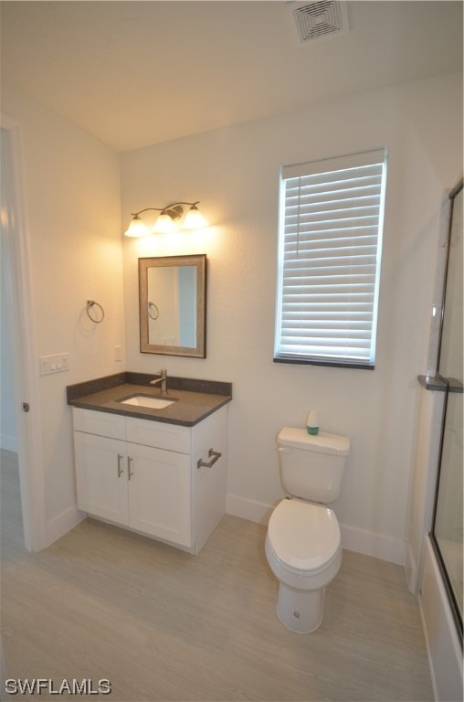 8581 Agate Street Port Charlotte, FL 33981 - Photo 28 of 50 a bathroom with a sink a toilet and mirror