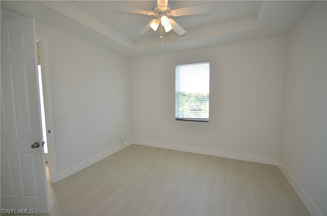 8581 Agate Street Port Charlotte, FL 33981 - Photo 29 of 50 an empty room with a window and a fan