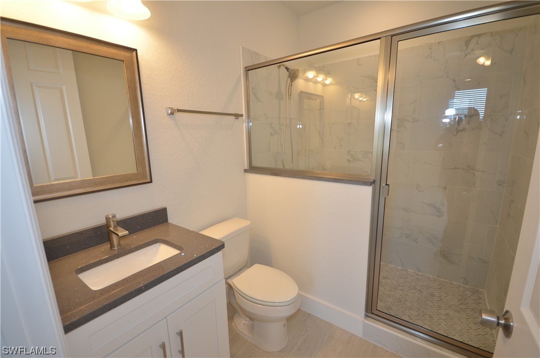 8581 Agate Street Port Charlotte, FL 33981 - Photo 35 of 50 a bathroom with a sink a toilet and shower