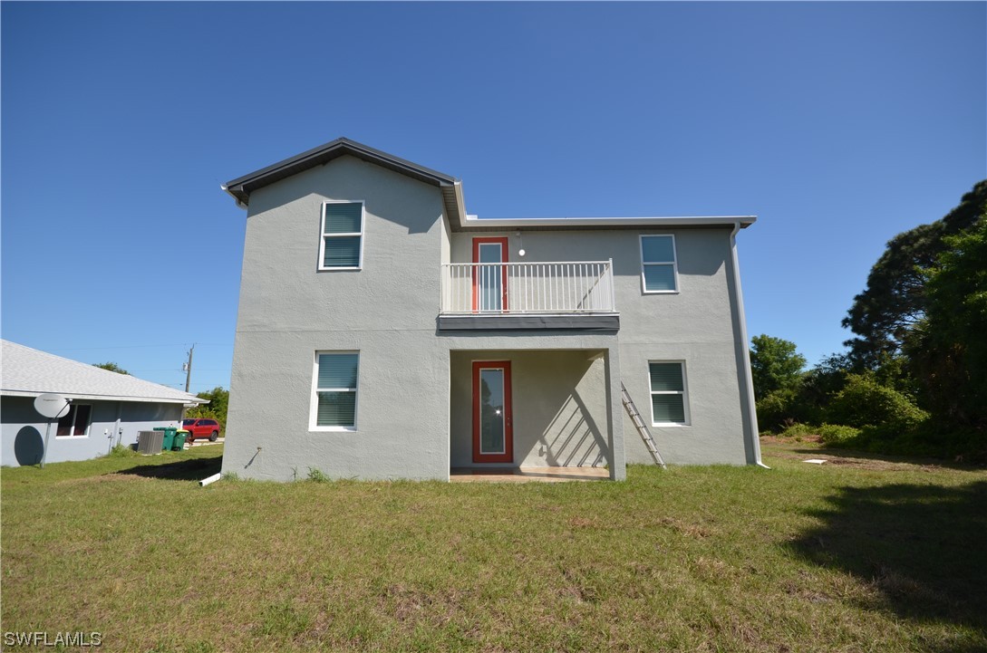 8581 Agate Street Port Charlotte, FL 33981 - Photo 40 of 50 a front view of a house with a yard and garage