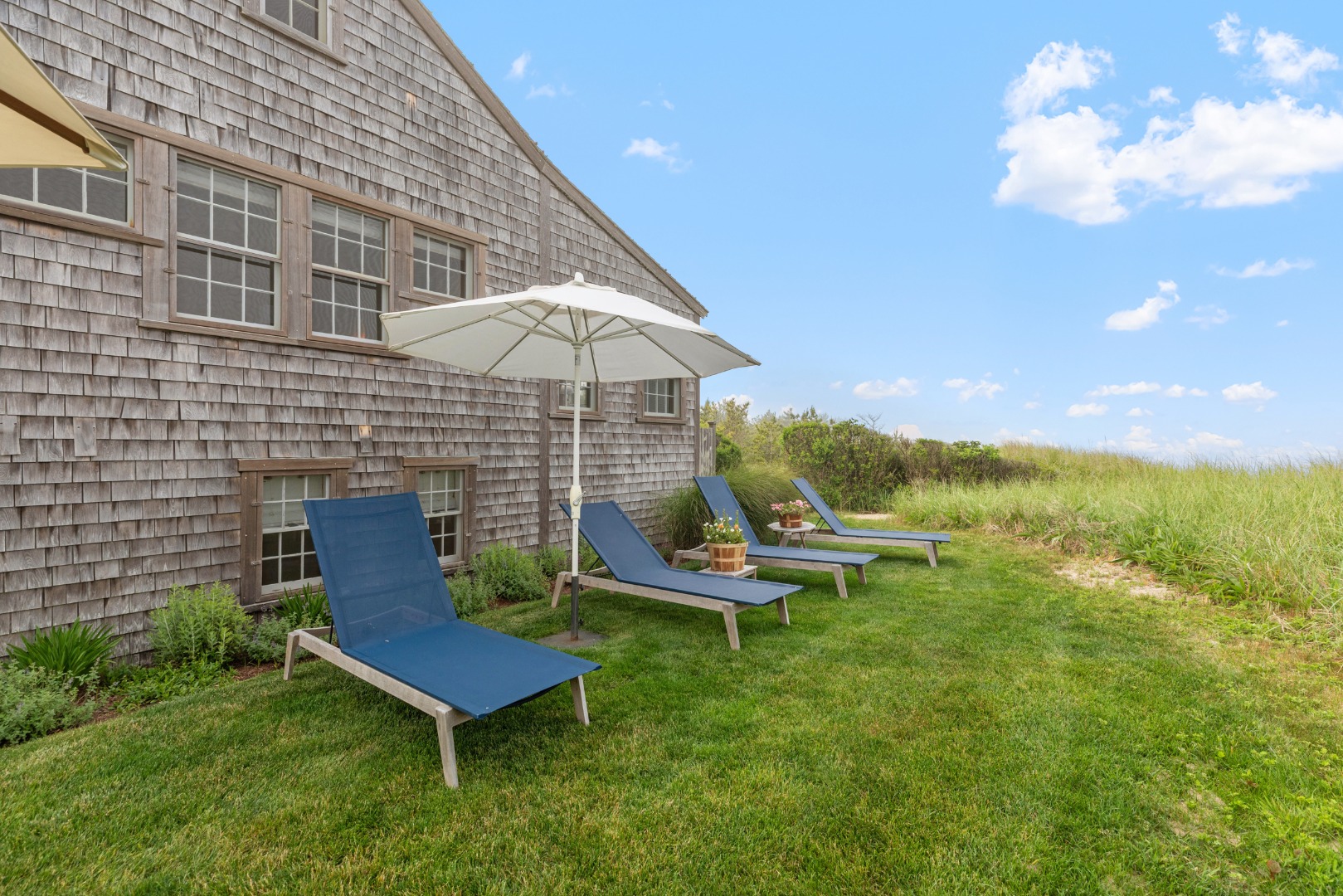 3 North Gully Road Nantucket, MA 02554 - Photo 32 of 43 a backyard of a house with table and chairs