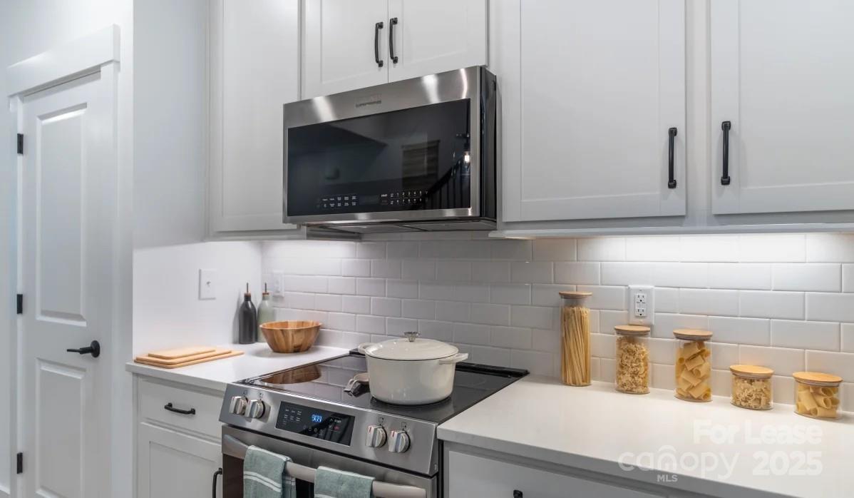 2019 Caldera Street Charlotte, NC 28208 - Photo 6 of 25 a kitchen with a stove and a microwave