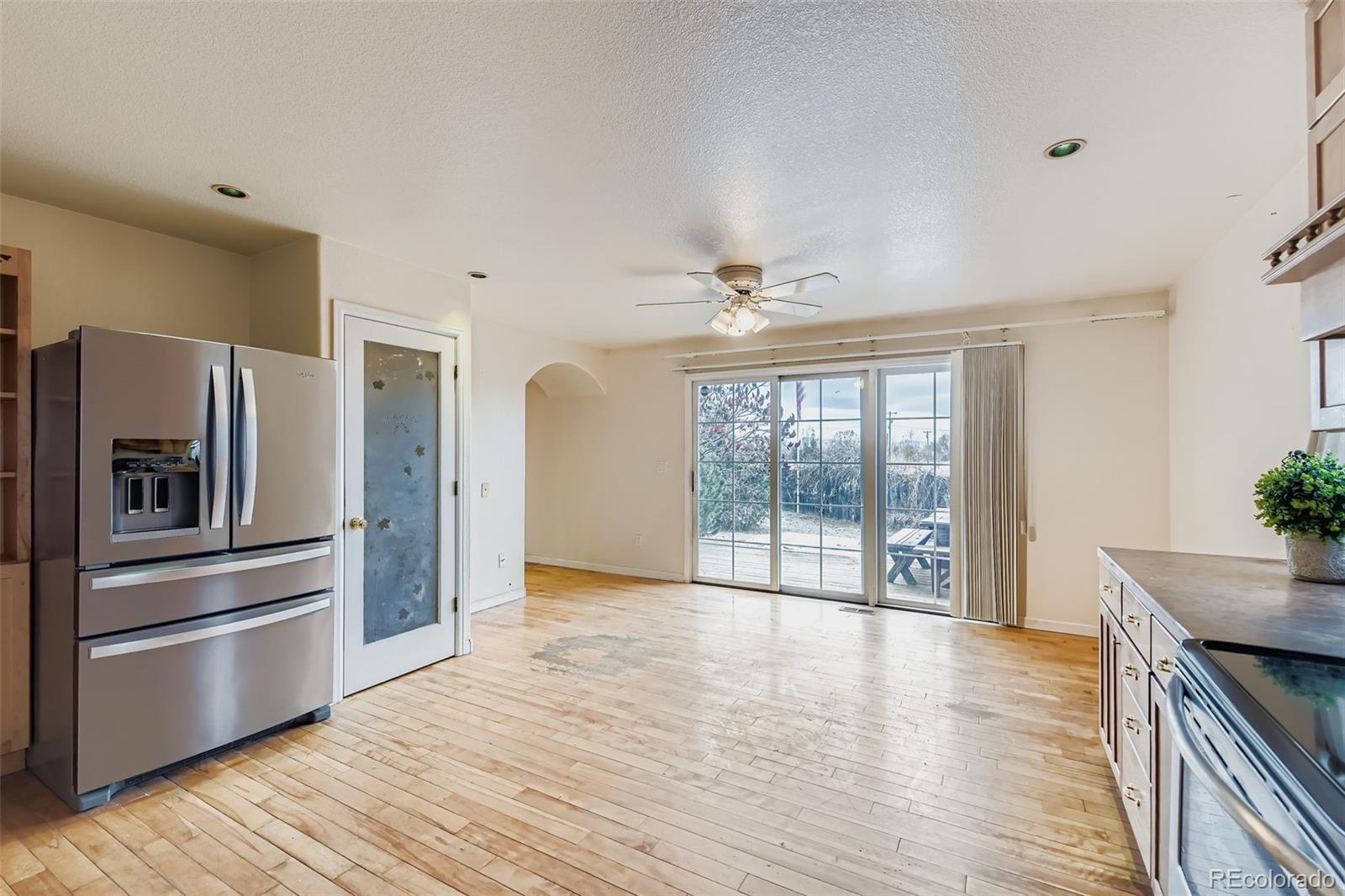 213 Elizabeth Court Fort Lupton, CO 80621 - Photo 11 of 27 a view of a kitchen with wooden floor electronic appliances and windows