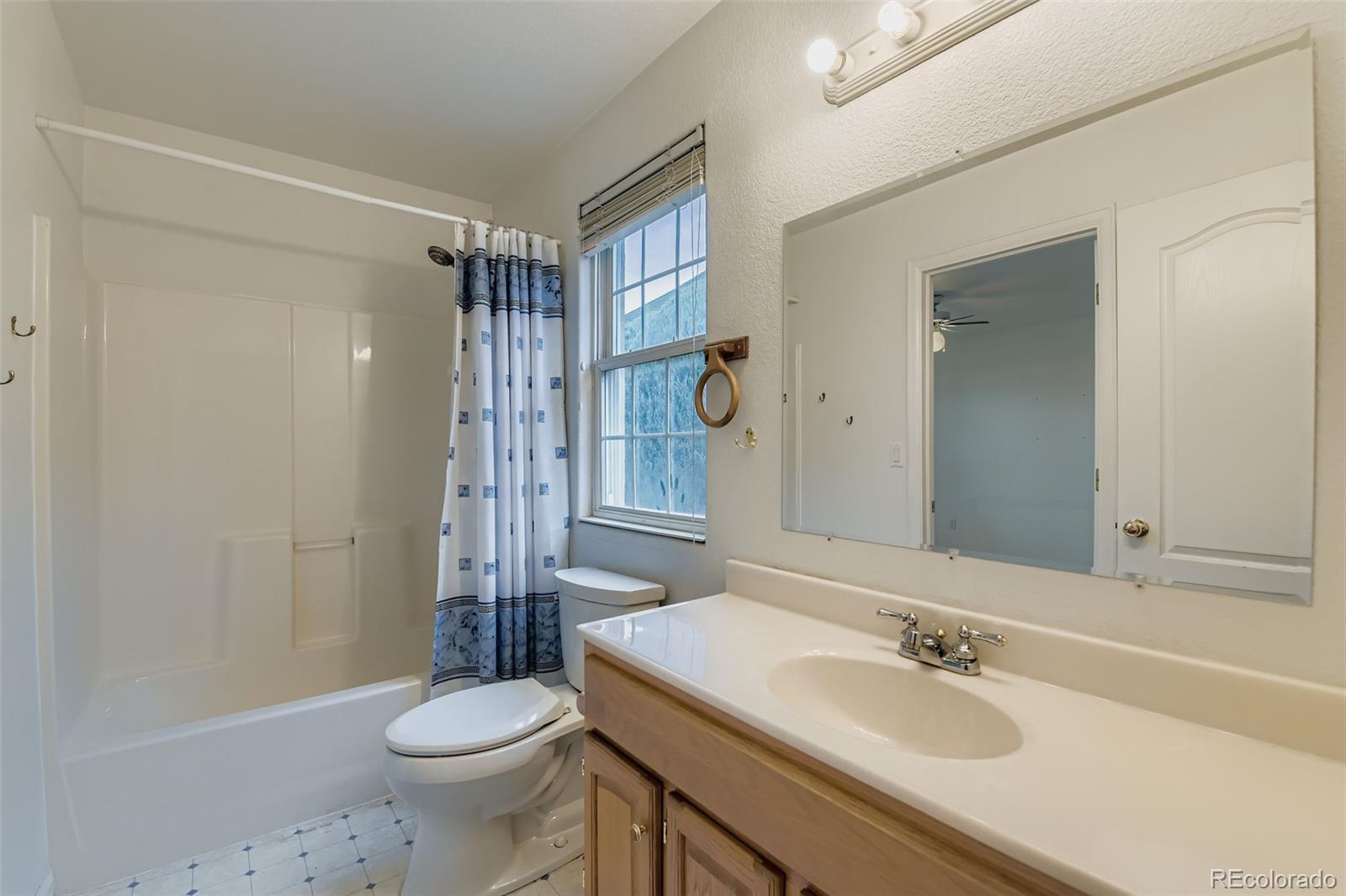 213 Elizabeth Court Fort Lupton, CO 80621 - Photo 13 of 27 a bathroom with a sink toilet and shower