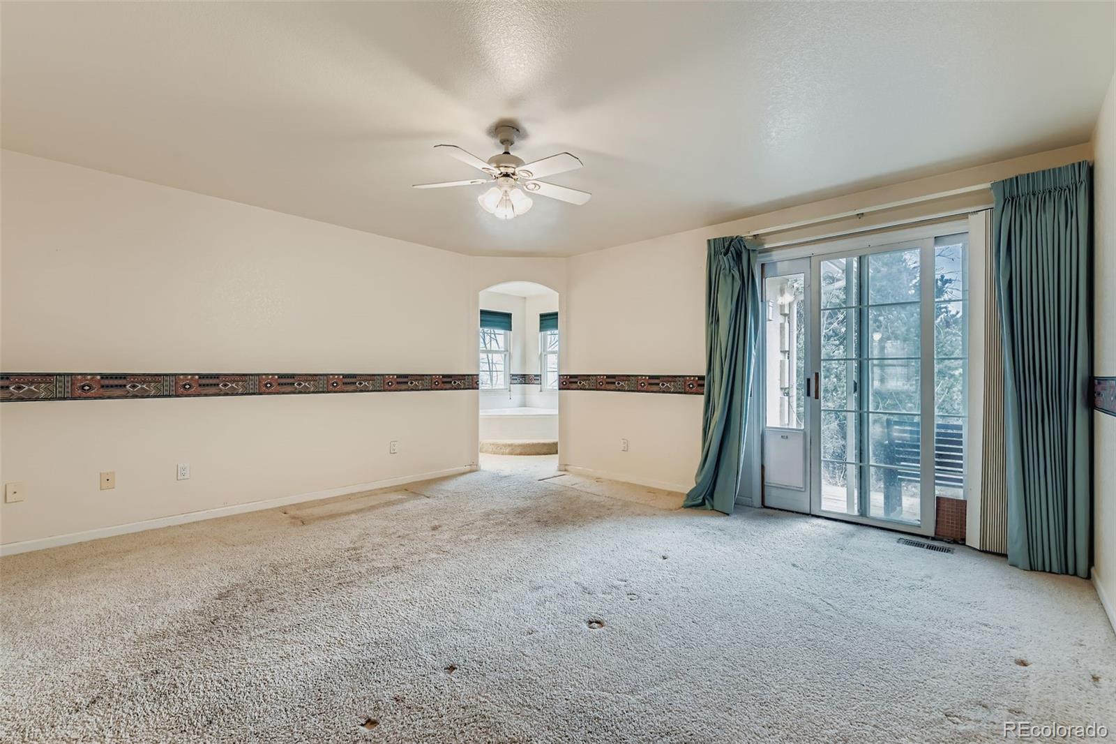 213 Elizabeth Court Fort Lupton, CO 80621 - Photo 14 of 27 a view of a livingroom with an empty space and a window