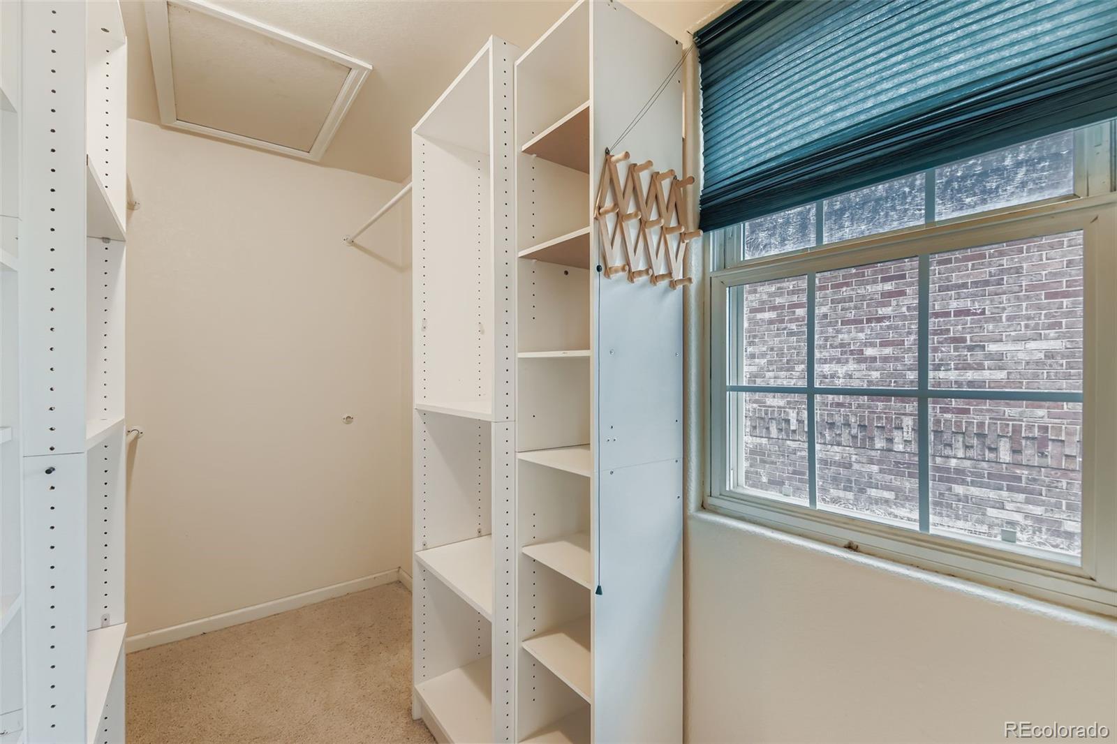 213 Elizabeth Court Fort Lupton, CO 80621 - Photo 19 of 27 a view of an empty room with a window and wooden floor