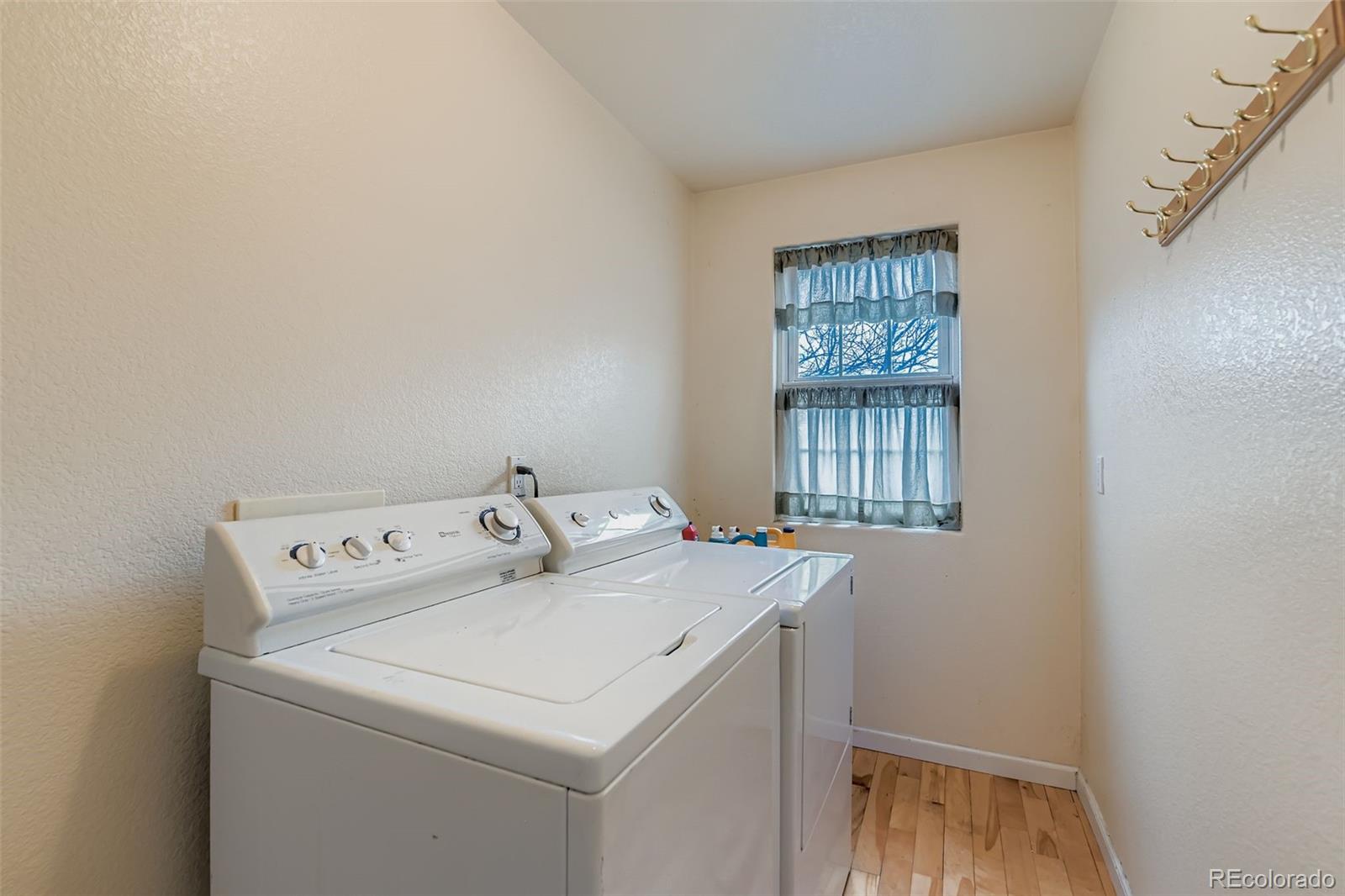 213 Elizabeth Court Fort Lupton, CO 80621 - Photo 22 of 27 a utility room with dryer and washer