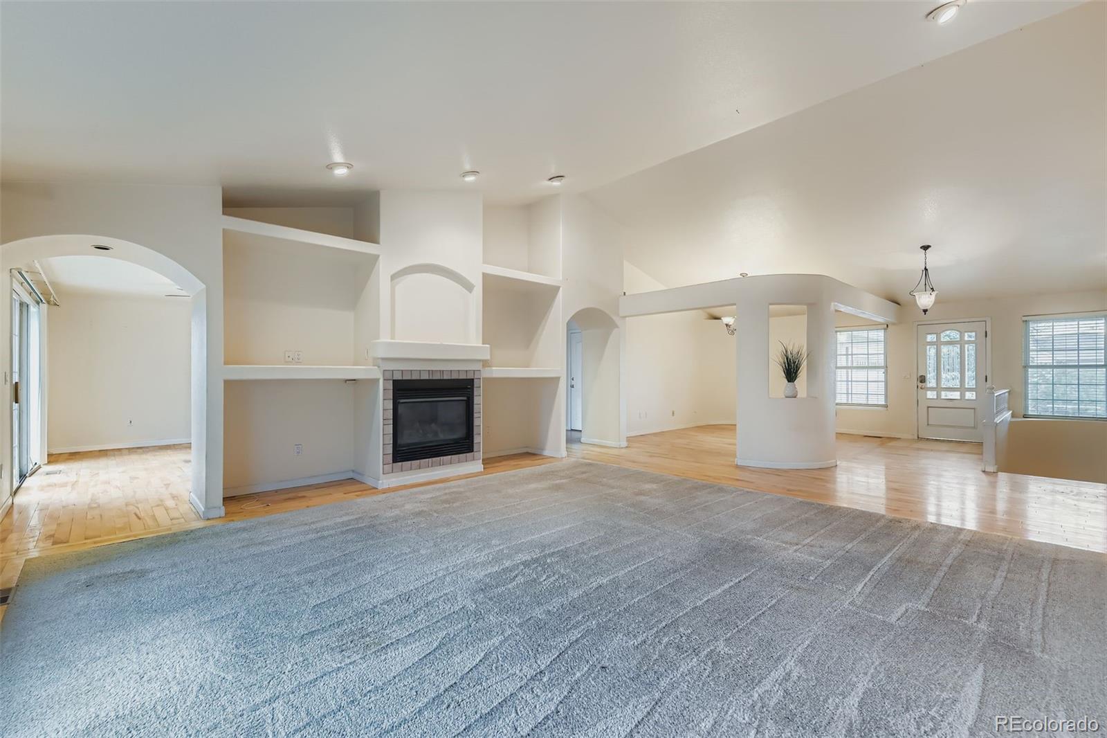 213 Elizabeth Court Fort Lupton, CO 80621 - Photo 7 of 27 a view of a kitchen with a sink and a fireplace