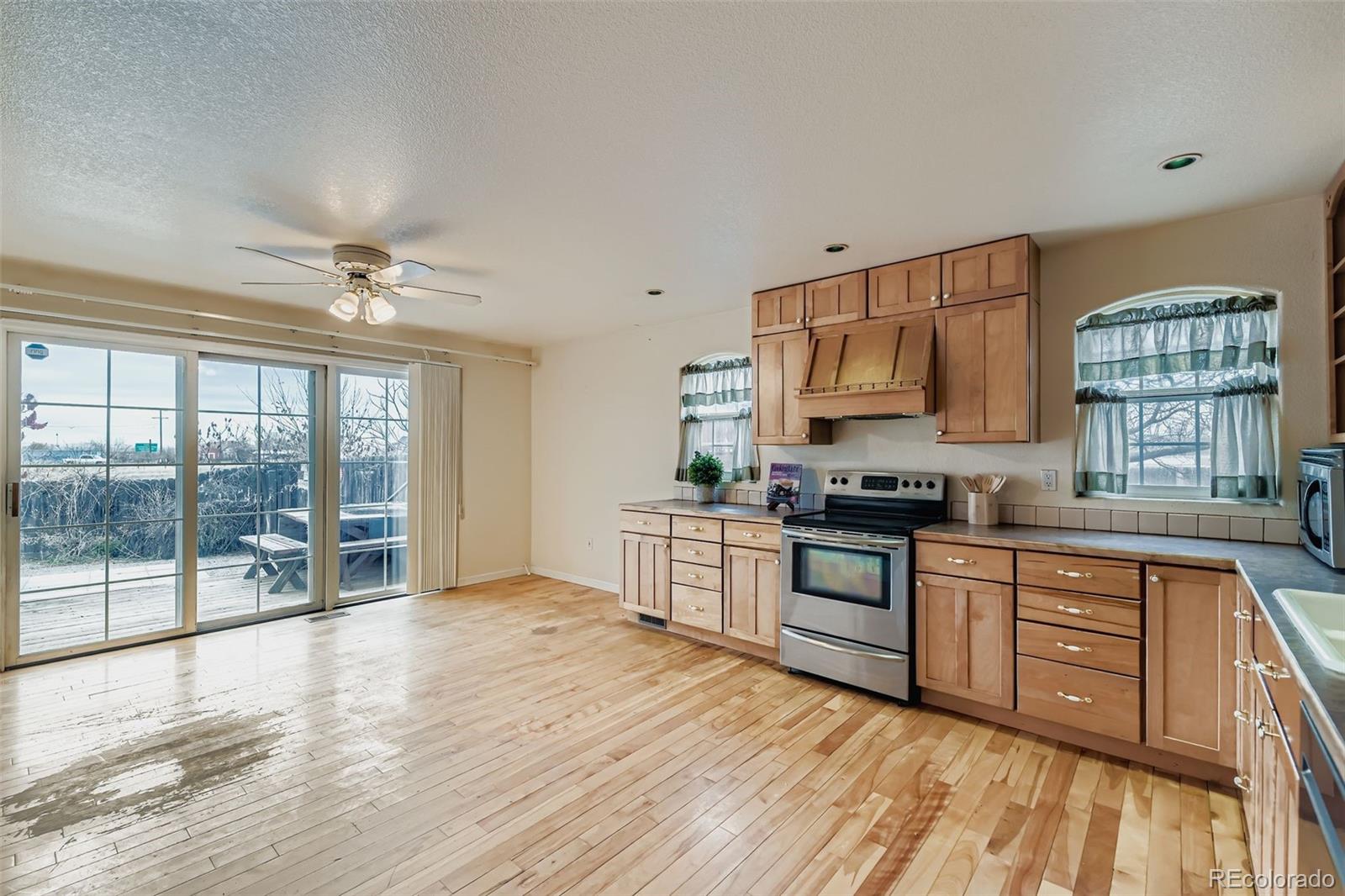 213 Elizabeth Court Fort Lupton, CO 80621 - Photo 9 of 27 a kitchen with stainless steel appliances granite countertop a stove and a sink
