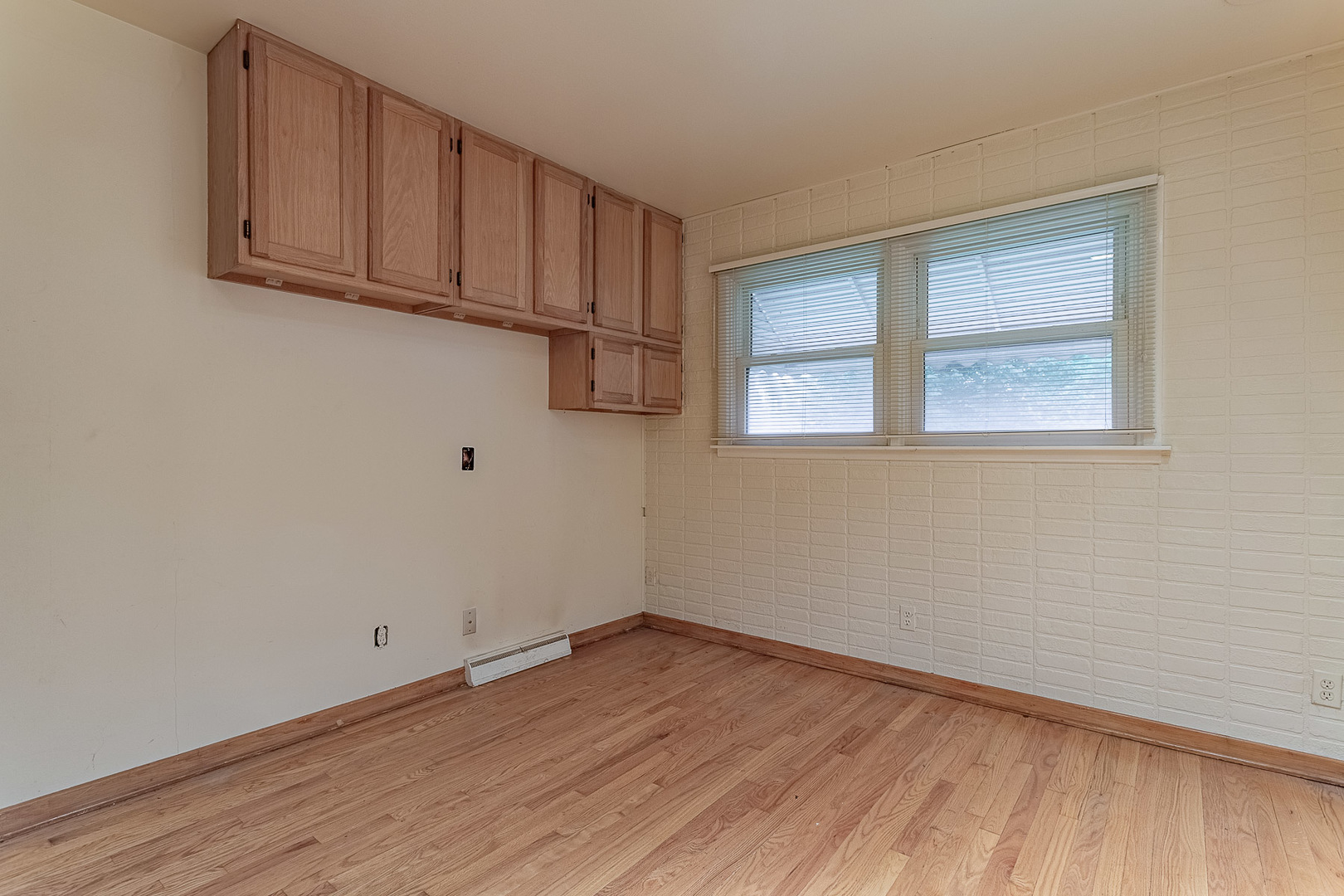 1506 West Palm Drive Mount Prospect, IL 60056 - Photo 12 of 19 a view of a room with wooden floor and cabinets