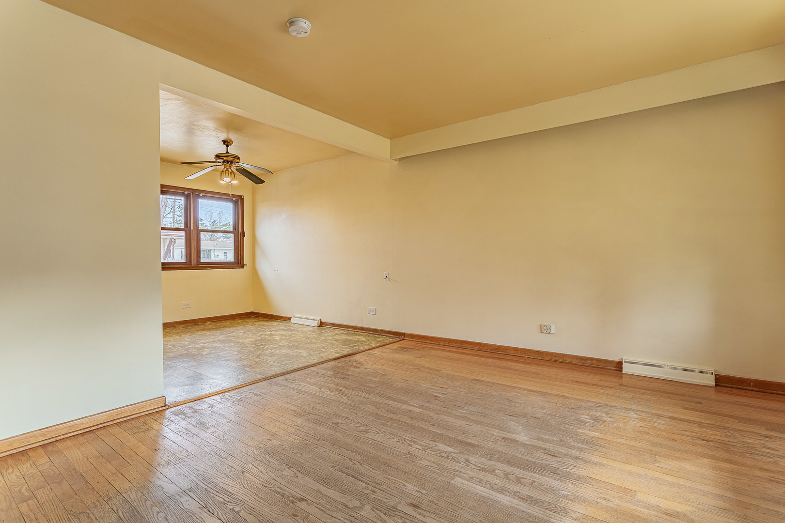 1506 West Palm Drive Mount Prospect, IL 60056 - Photo 4 of 19 an empty room with wooden floor and windows