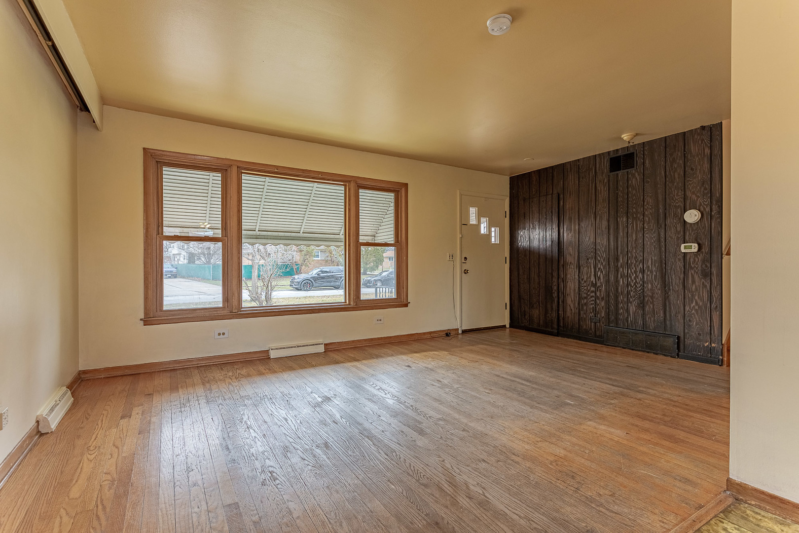 1506 West Palm Drive Mount Prospect, IL 60056 - Photo 5 of 19 an empty room with wooden floor and windows