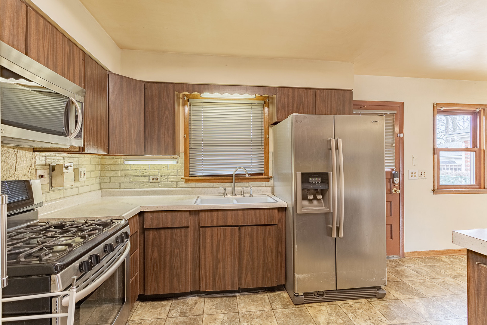 1506 West Palm Drive Mount Prospect, IL 60056 - Photo 7 of 19 a kitchen with stainless steel appliances granite countertop a refrigerator and a stove top oven