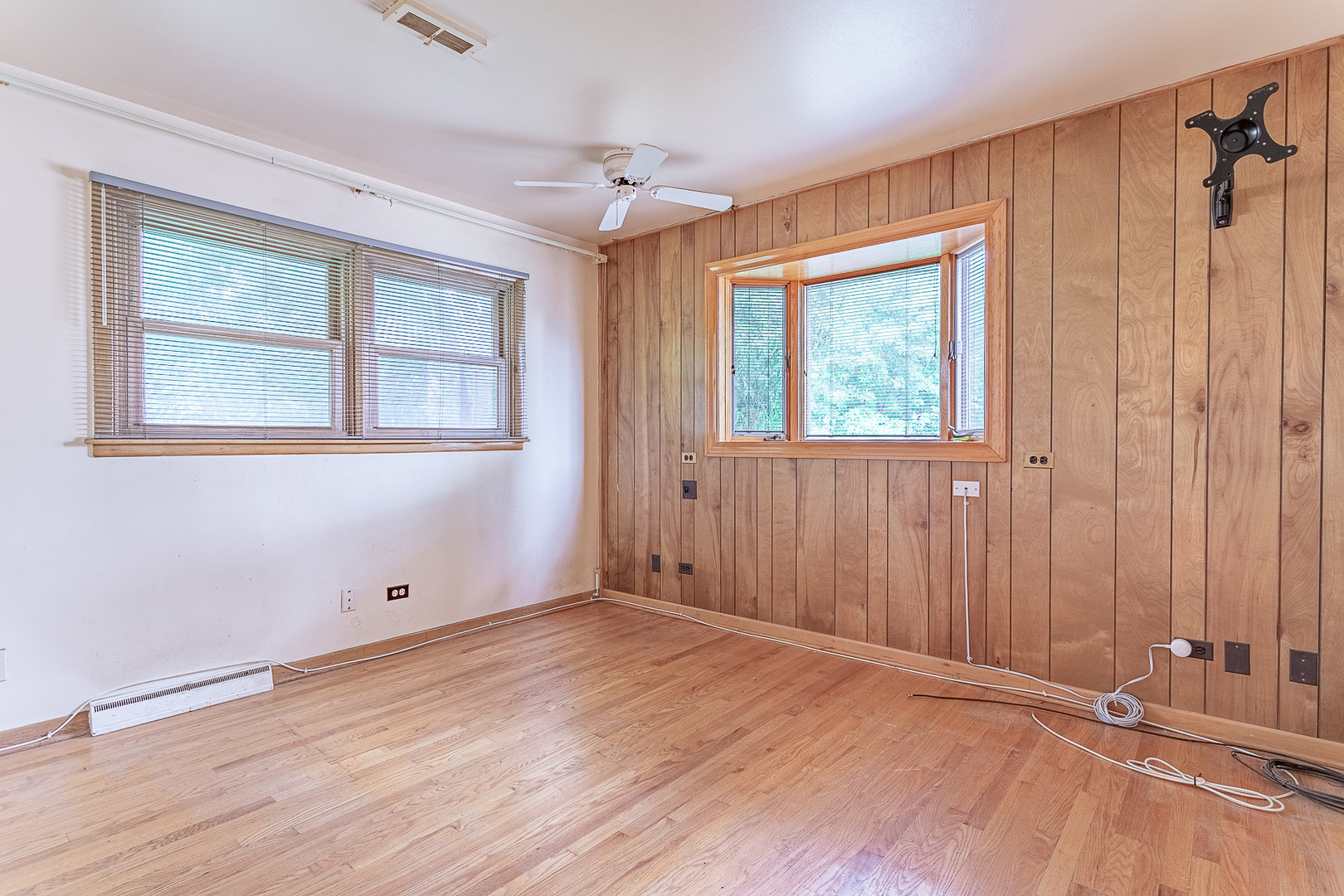1506 West Palm Drive Mount Prospect, IL 60056 - Photo 10 of 19 an empty room with wooden floor and windows