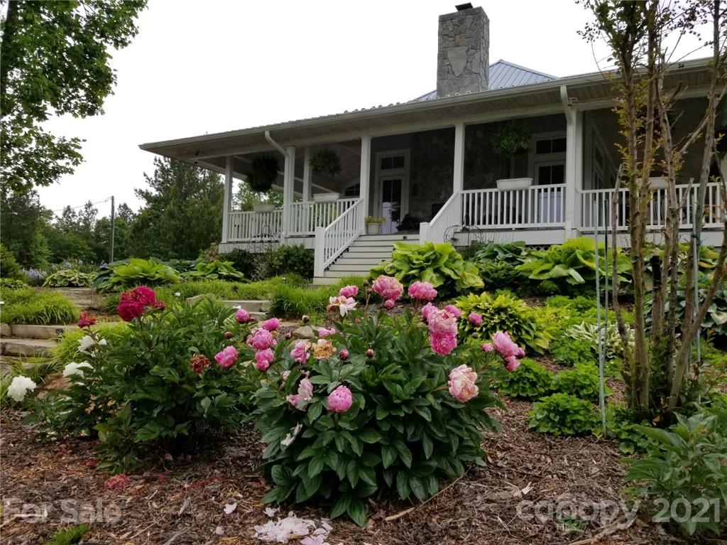 94 Pilot Ridge Road, Unit 22 Nebo, NC 28761 - Photo 21 of 32 a front view of a house with a yard and fountain