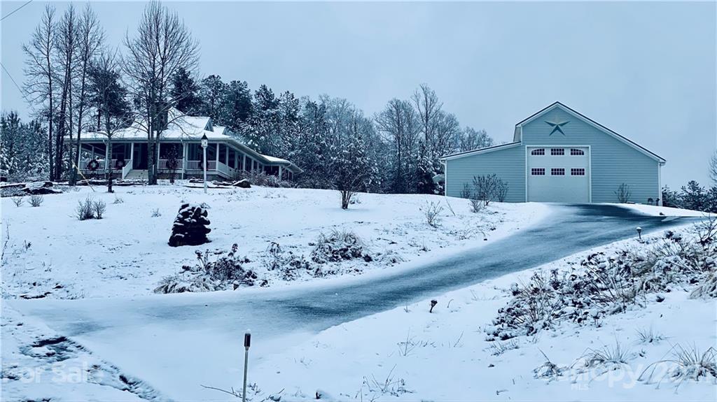 94 Pilot Ridge Road, Unit 22 Nebo, NC 28761 - Photo 24 of 32 a view of a large white covered with snow in front of house