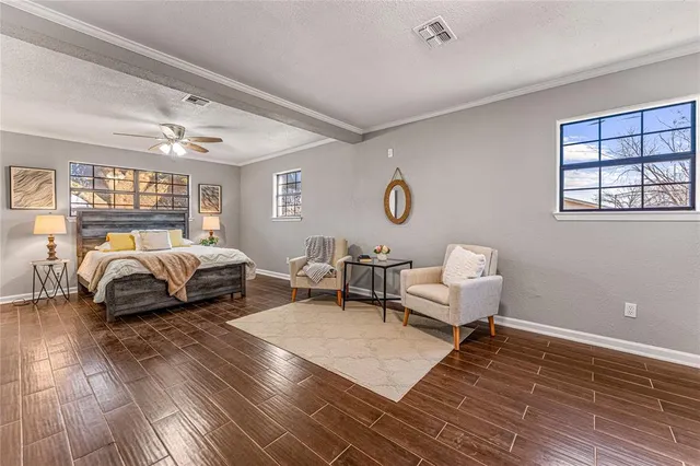 a spacious bedroom with a bed couch and a window