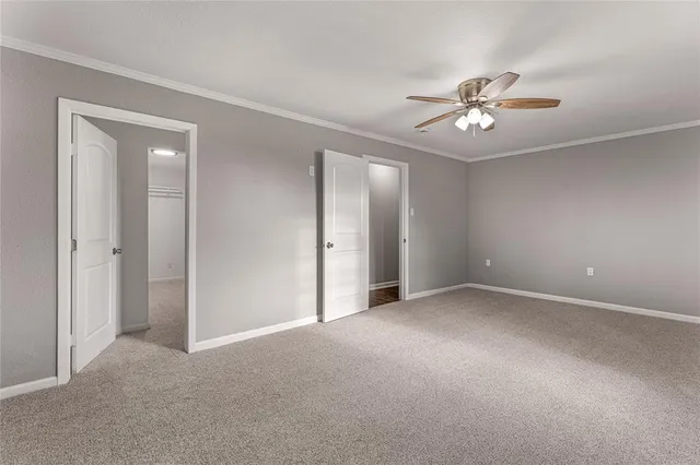 a view of an empty room with a fan