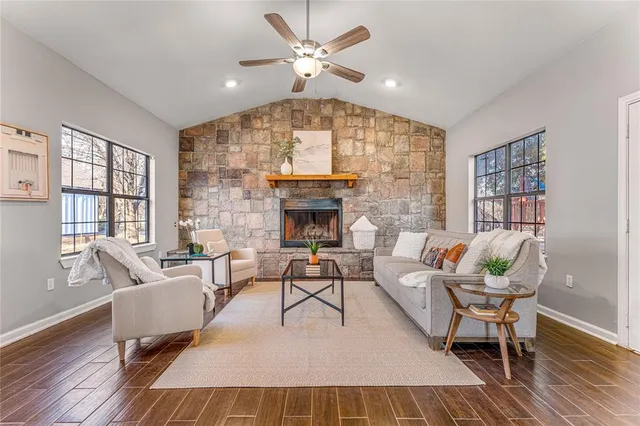 a living room with furniture and a fireplace