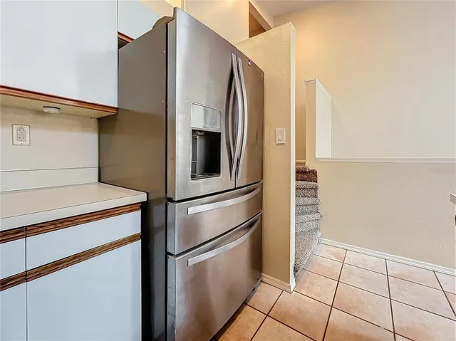 a metallic refrigerator freezer sitting in a kitchen