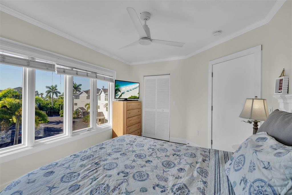 848 Evergreen Way Longboat Key, FL 34228 - Photo 29 of 66 a bedroom with a bed and wooden floor