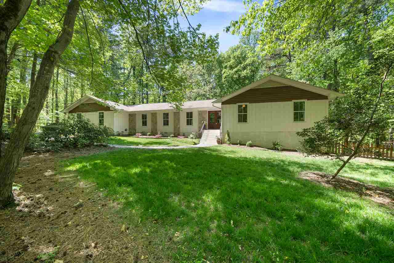 9421 Barton Creek Road Raleigh, NC 27615 - Photo 18 of 30 a front view of a house with a yard table and chairs