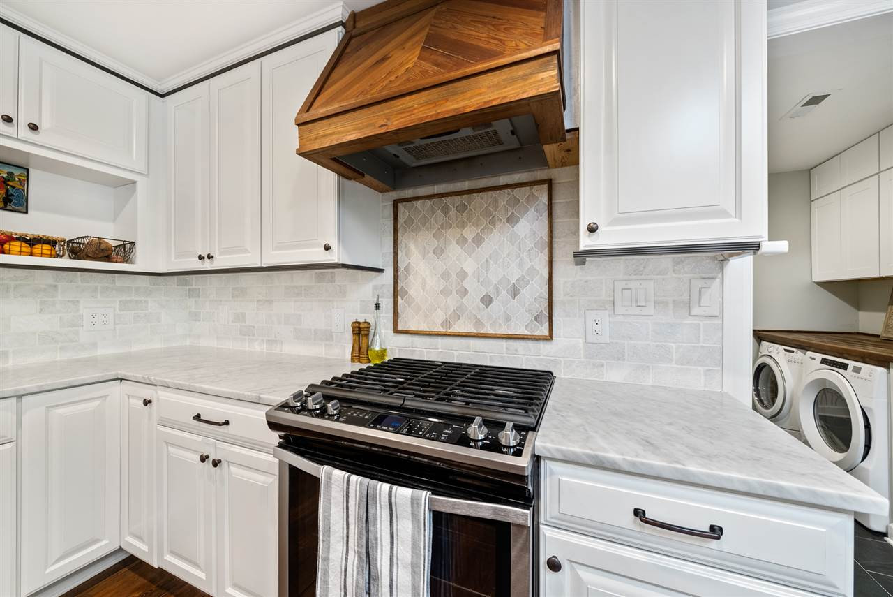 9421 Barton Creek Road Raleigh, NC 27615 - Photo 3 of 30 a kitchen with granite countertop cabinets stainless steel appliances and wooden floor