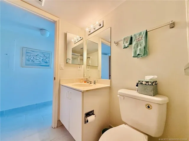 a view of a garage with table and chairs under an umbrella