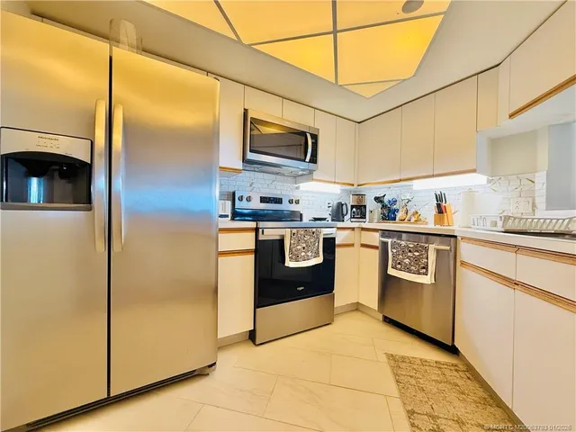 a dining room with furniture and a chandelier